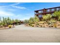 Gated community entrance leading to a hillside home with an attached garage at 16364 E Ridgeline Dr, Fountain Hills, AZ 85268