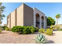 A neutral-toned building featuring manicured greenery and decorative gravel showcasing the building's exterior at 16852 E La Montana Dr # C18, Fountain Hills, AZ 85268