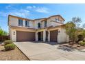 Beautiful home featuring two garages, desert landscaping, and a quaint front porch at 17153 W Gambit Trl, Surprise, AZ 85387
