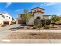 Charming two-story home featuring a three-car garage, desert landscaping and a private front yard at 17153 W Gambit Trl, Surprise, AZ 85387