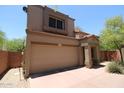Two-story home with a neutral-colored stucco exterior, red tile roof, and a two-car garage at 17606 N 17Th Pl # 1096, Phoenix, AZ 85022