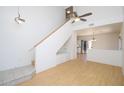 Bright living room features vaulted ceilings, light-colored wood floors, and a staircase with built-in storage at 17606 N 17Th Pl # 1096, Phoenix, AZ 85022