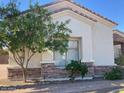Charming single-story home with stone accents and manicured landscaping, providing great curb appeal at 18029 W San Miguel Ave, Litchfield Park, AZ 85340