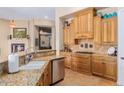 Bright kitchen with custom cabinets, granite countertops, and a tile backsplash at 18029 W San Miguel Ave, Litchfield Park, AZ 85340