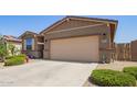 Picture of the facade of a one-story home with neutral paint and a two-car garage at 18637 W Williams Rd, Surprise, AZ 85387