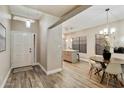 Inviting entryway leading to the dining area, featuring new flooring and modern lighting at 2110 W Navarro Ave, Mesa, AZ 85202