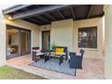 Relax on this covered patio with stylish seating, overlooking the well-maintained backyard and lush landscaping at 2110 W Navarro Ave, Mesa, AZ 85202