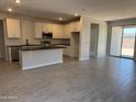 Modern kitchen featuring white cabinets, stainless steel appliances, a center island, and tile floors at 22913 N 183Rd Dr, Surprise, AZ 85387