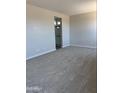 Spacious main bedroom with plush carpeting and access to the ensuite bathroom at 22913 N 183Rd Dr, Surprise, AZ 85387