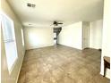 Bright, spacious living room features neutral paint, tile flooring, and a ceiling fan at 23284 W Pima St, Buckeye, AZ 85326