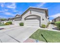 Attached two-car garage with a clean concrete driveway and well-maintained landscaping at 23753 S Vacation Way, Sun Lakes, AZ 85248
