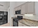 Functional kitchen with stainless steel appliances, tile floors and stone countertops at 23753 S Vacation Way, Sun Lakes, AZ 85248