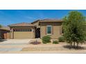 Charming single-story home featuring a well-manicured yard and a neutral color palette at 24478 N 166Th Ave, Surprise, AZ 85387