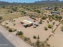 Aerial shot of a desert home and its expansive lot with sparse vegetation and mountain views at 270 S Ralston Rd, Maricopa, AZ 85139