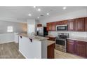 Well-lit kitchen featuring stainless steel appliances, granite countertops, and a breakfast bar at 2941 E Darrow St, Phoenix, AZ 85042