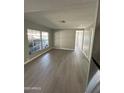 Bright living room featuring new flooring and natural light from multiple windows at 300 S Val Vista Dr # 17, Mesa, AZ 85204