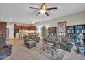 Expansive living area boasts plush leather seating, ceiling fans, and an adjacent open-concept kitchen at 3125 W Desert Ln, Laveen, AZ 85339