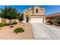Two-story home with desert landscaping, neutral paint, arched entryway, and two-car garage at 35919 N Loemann Dr, San Tan Valley, AZ 85143