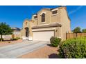 Two-story home with desert landscaping, neutral paint, arched entryway, and two-car garage at 35919 N Loemann Dr, San Tan Valley, AZ 85143
