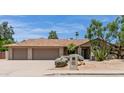 Charming home featuring a three-car garage, desert landscaping and a well-manicured lawn at 4532 E Sandra Ter, Phoenix, AZ 85032