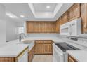 An updated kitchen with new appliances, white countertops, and wooden cabinets at 461 W Holmes Ave # 180, Mesa, AZ 85210