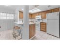 An updated kitchen with white countertops, wood cabinets, and stainless steel appliances at 461 W Holmes Ave # 180, Mesa, AZ 85210
