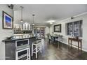Stylish kitchen and dining area featuring modern bar seating, sleek countertops, and ample natural light at 4610 N 14Th Ave, Phoenix, AZ 85013