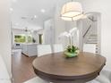 Bright dining room with an exquisite chandelier and modern staircase overlooking a spacious kitchen at 4700 S Fulton Ranch Blvd # 11, Chandler, AZ 85248
