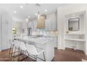 Stylish kitchen with white cabinets, a large island with seating, and elegant pendant lighting at 4700 S Fulton Ranch Blvd # 11, Chandler, AZ 85248