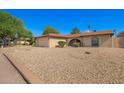 Single-story home featuring an attached two-car garage and desert landscaping at 4957 W Onyx Ave, Glendale, AZ 85302
