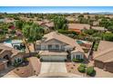 Two-story home featuring a three-car garage, well-maintained landscaping, and a backyard pool at 6102 E Danbury Rd, Scottsdale, AZ 85254