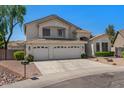 Two-story home featuring a three-car garage and desert landscaping at 6102 E Danbury Rd, Scottsdale, AZ 85254