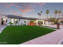 Beautiful single-story home with lush lawn, mature palm trees, and modern fence at 720 E Chilton Dr, Tempe, AZ 85283