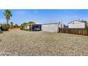 Spacious gravel yard with covered parking and well-maintained mobile home at 7711 E Farmdale Ave, Mesa, AZ 85208