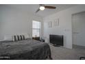 Comfortable bedroom featuring a ceiling fan, large bed, and bright natural light at 7712 S 64Th Ln, Laveen, AZ 85339
