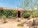 This single-story house features a drought-resistant yard with brick accents and climbing plants at 8116 N 55Th Dr, Glendale, AZ 85302