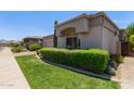 View of the front exterior of the home showcasing the desert landscaping and a paver driveway at 8689 E Krail St, Scottsdale, AZ 85250