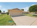 Residential house with a spacious driveway and well-maintained lawn, showcasing suburban charm at 9802 N Balboa Dr, Sun City, AZ 85351