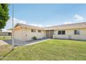 Street view of a single-story home featuring a well-kept lawn and appealing architectural details at 9802 N Balboa Dr, Sun City, AZ 85351