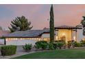 Beautiful home featuring a well-manicured front lawn, mature trees, and a spacious three-car garage at 9921 E Doubletree Ranch Rd, Scottsdale, AZ 85258