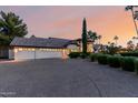 Expansive home with a long driveway, three-car garage, and lush landscaping at 9921 E Doubletree Ranch Rd, Scottsdale, AZ 85258
