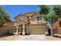 Beautiful two-story home with a welcoming entrance and attached two car garage at 10036 W Chipman Rd, Tolleson, AZ 85353