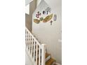 Elegant staircase with white railings leading to upper level, accented with unique wall art at 10036 W Chipman Rd, Tolleson, AZ 85353