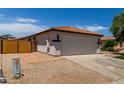 Charming single-story home with a well-manicured front yard and a spacious two-car garage at 10408 W Miami St, Tolleson, AZ 85353