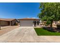 Charming single-story home with a well-manicured front yard and a spacious two-car garage at 10408 W Miami St, Tolleson, AZ 85353