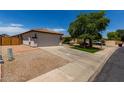 Charming single-story home with a well-manicured front yard and a spacious two-car garage at 10408 W Miami St, Tolleson, AZ 85353