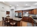 Well-equipped kitchen featuring a granite countertop island, stainless steel appliances, and ample cabinet space at 11253 E Peterson Ave, Mesa, AZ 85212