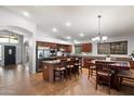 Spacious kitchen featuring stainless steel appliances and a granite countertop island with breakfast bar at 11253 E Peterson Ave, Mesa, AZ 85212