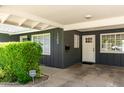 Covered front entrance with a modern door, security system, and visible house number at 1209 W Colter St, Phoenix, AZ 85013