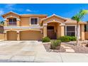 Inviting two-story home showcasing a well-manicured lawn and a spacious three-car garage at 13324 W Annika Dr, Litchfield Park, AZ 85340